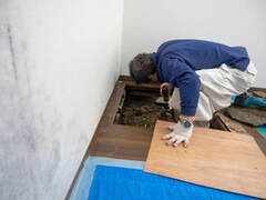 Contractors fixing a broken foundation in a home